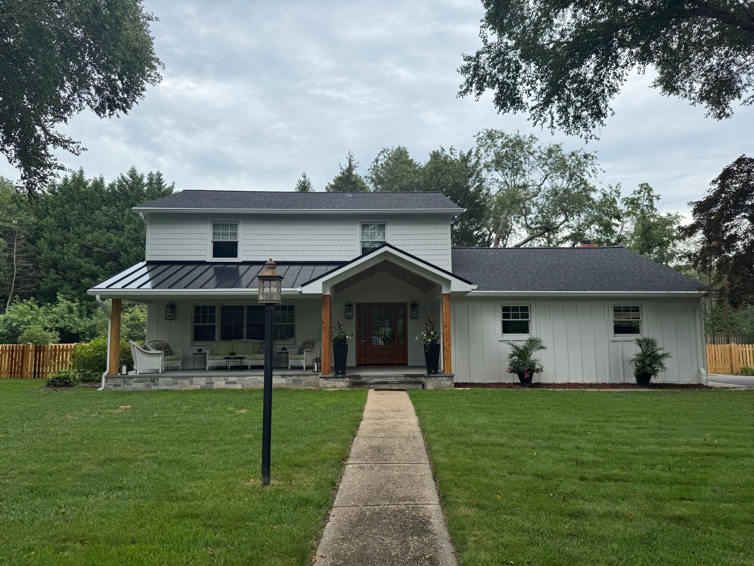 entire exterior renovation by Fichtner home exteriors siding, metal roof, portico, chimney rebuild