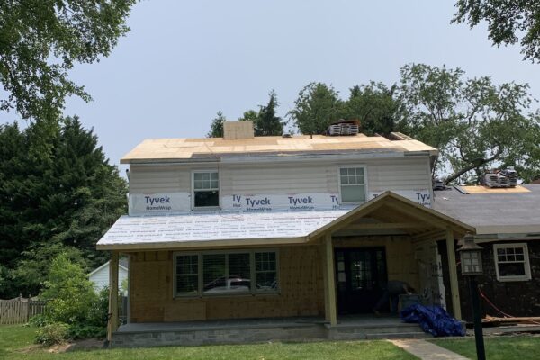 home improvement in progress new porch, siding and standing seam metal roof over portico