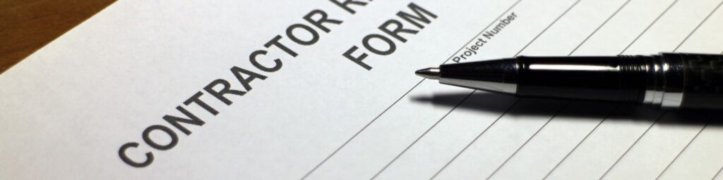 A contractor registration form with a pen, representing the licensing documentation required for Maryland roofing contractors.
