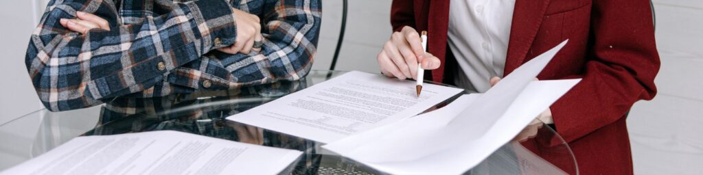 A contractor reviewing insurance documents with a homeowner, illustrating the importance of verifying roofing contractor insurance in Maryland.
